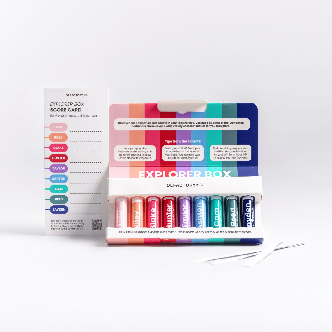 A minimalist desk with a lamp, plant, laptop, notebooks, and coffee beans.