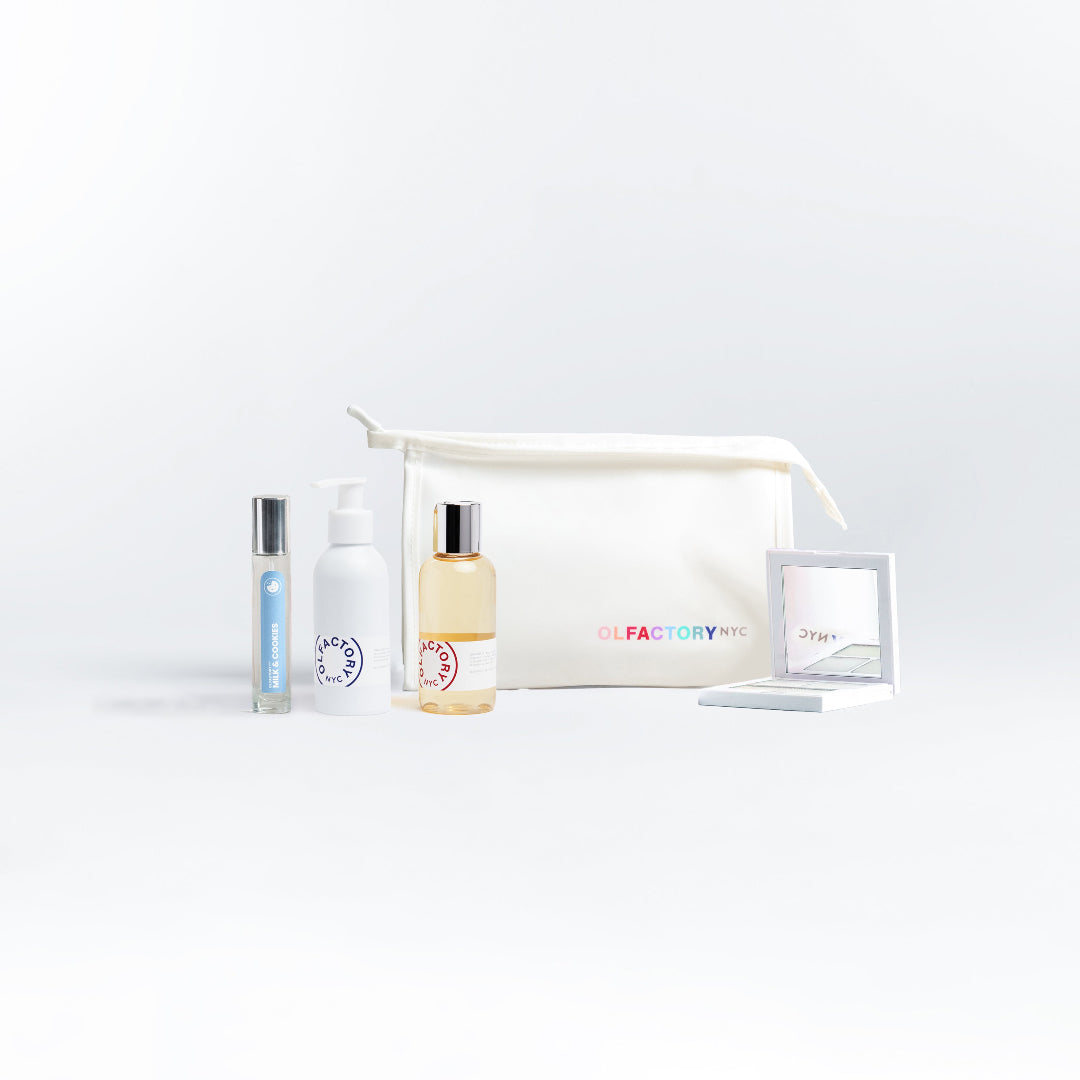 A minimalist desk with a lamp, plant, laptop, notebooks, and coffee beans.